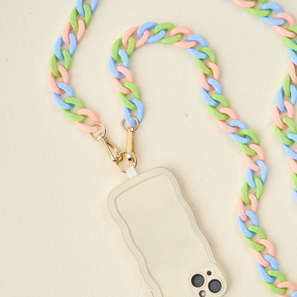blue. green, and pinkphone chain with phone attached arranged on an off-white background.