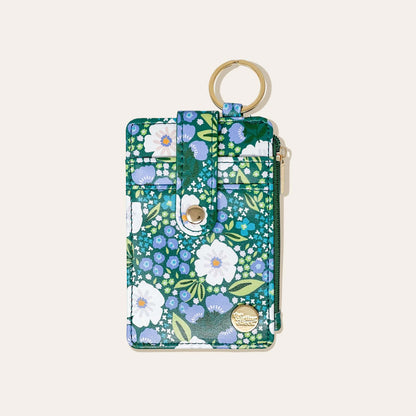 green wallet with blue and white floral design on a white background.