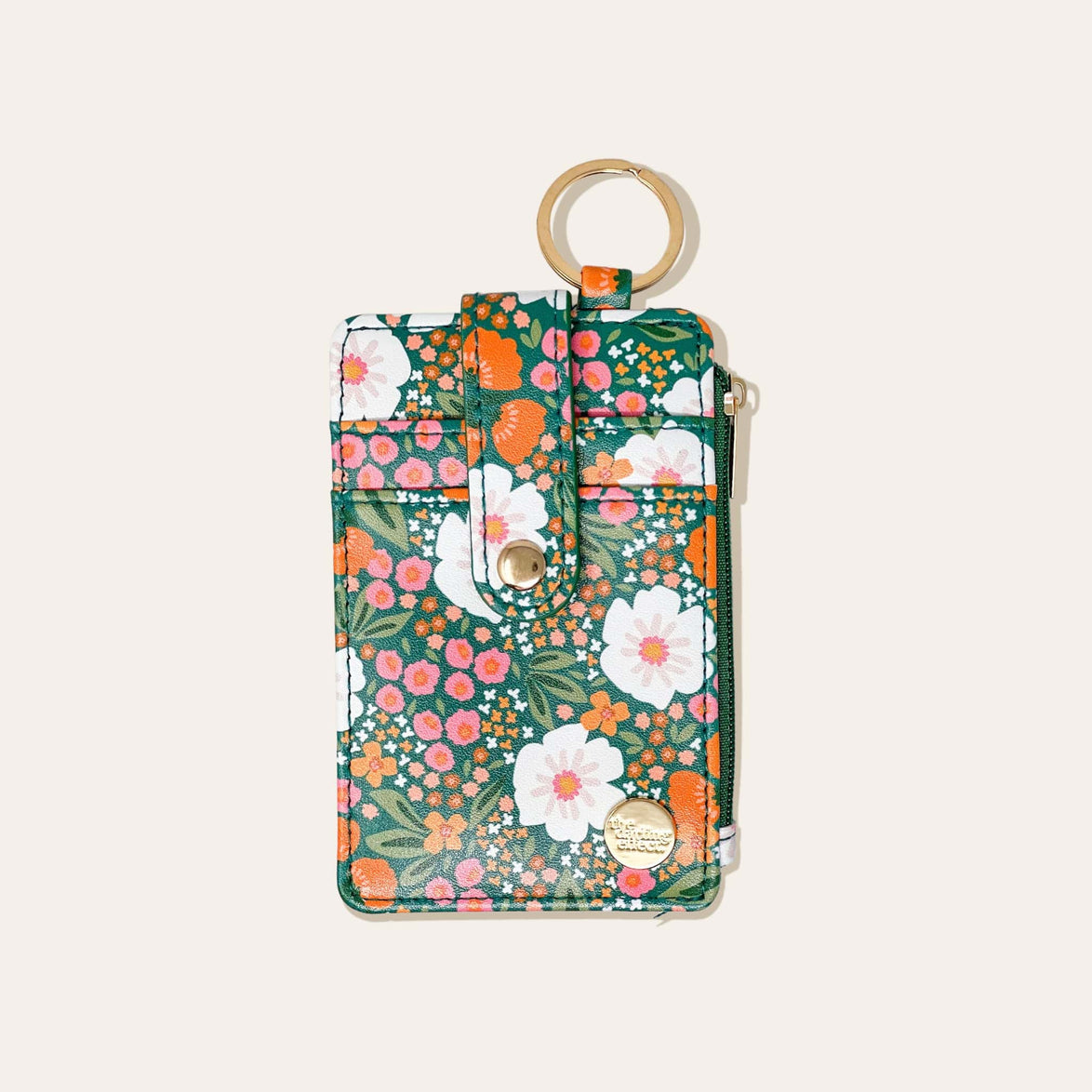 green wallet with orange and white floral design on a white background.