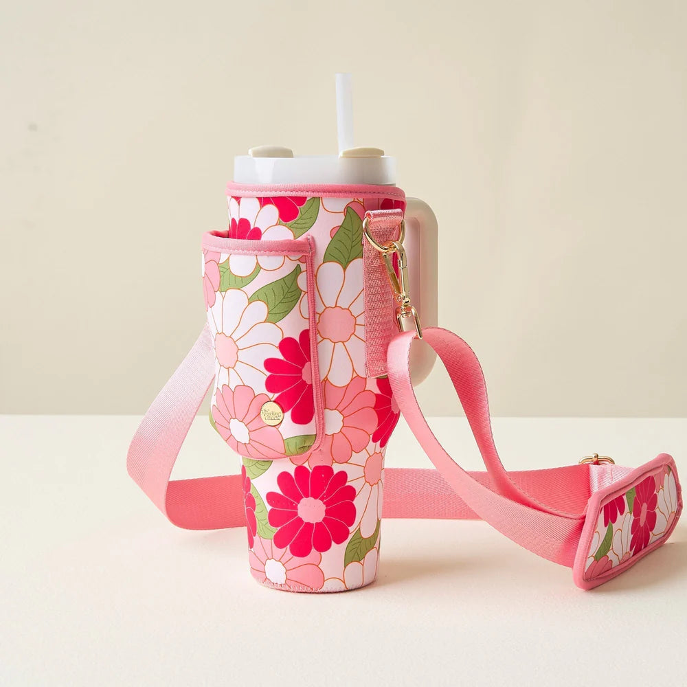 crazy daisy hot pink tumbler sling set on an off-white table.