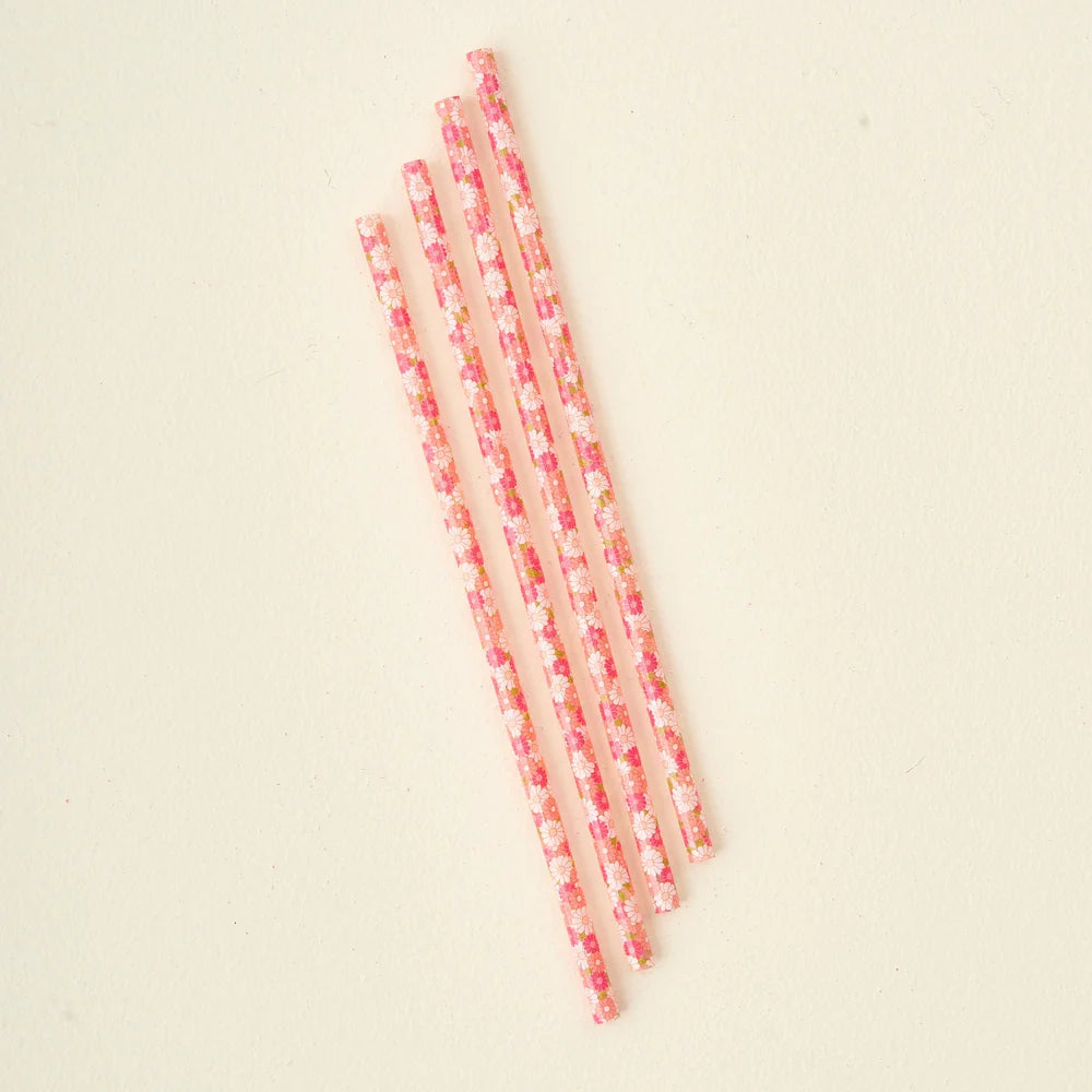 4 pink daisy craze straws arranged diagonally in a row.