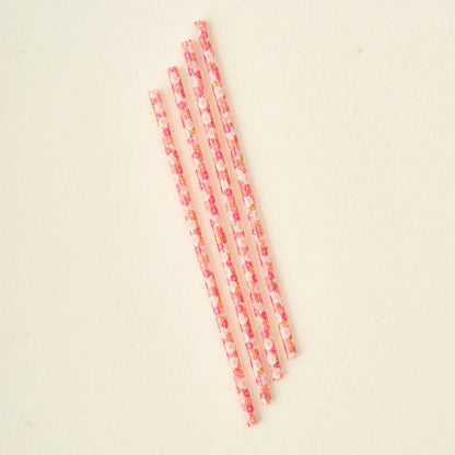 4 pink daisy craze straws arranged diagonally in a row.