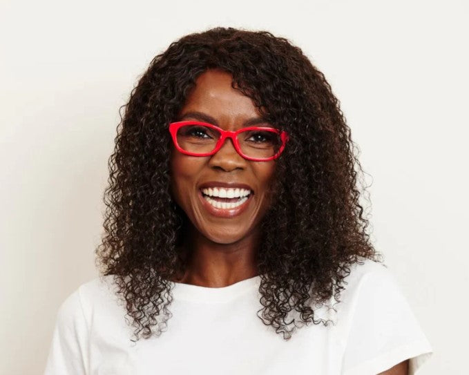 front view of a woman modeling the pink Good Morning Charlie Blue Light Reading Glasses against a white background