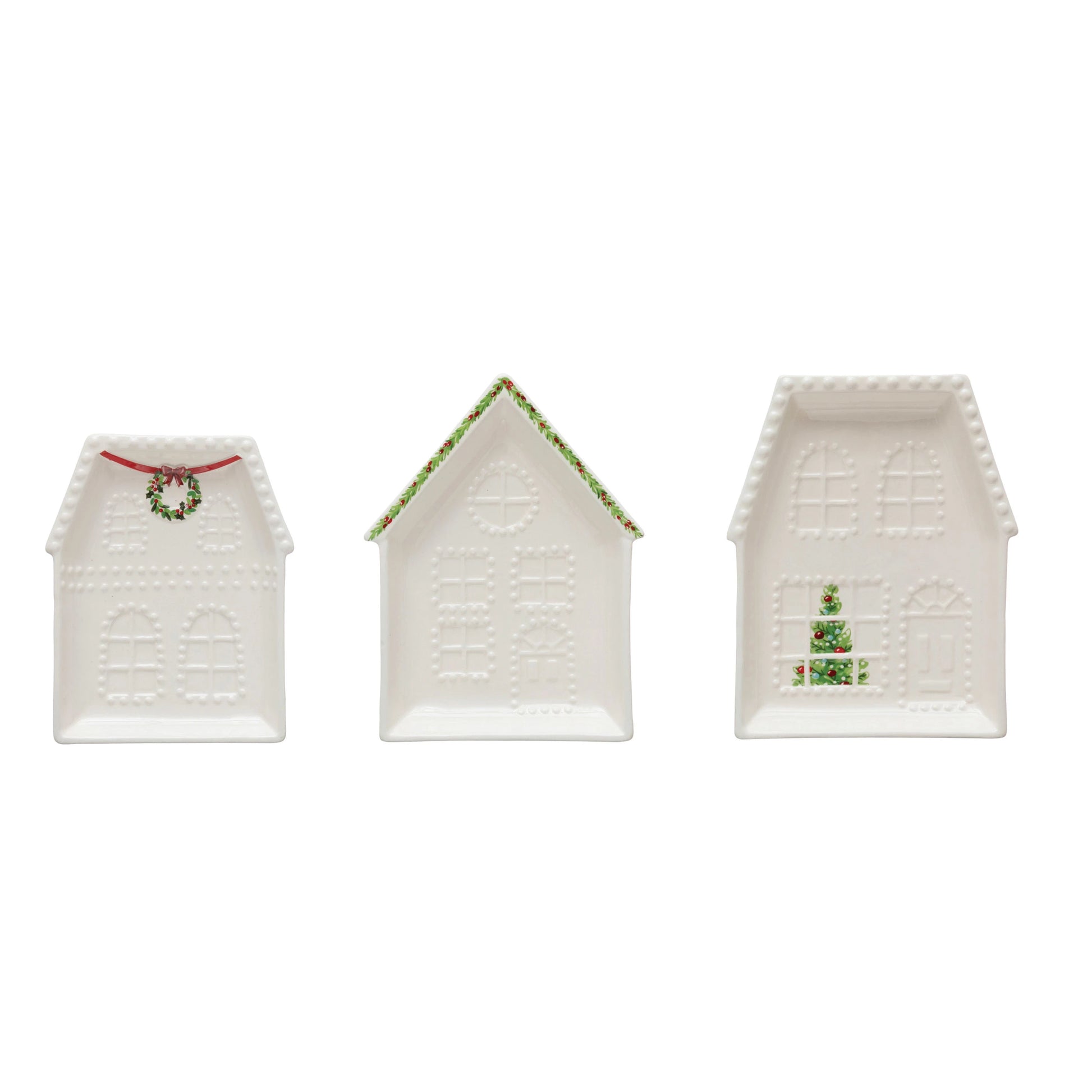 Three house shaped little plates in a row on a white background.