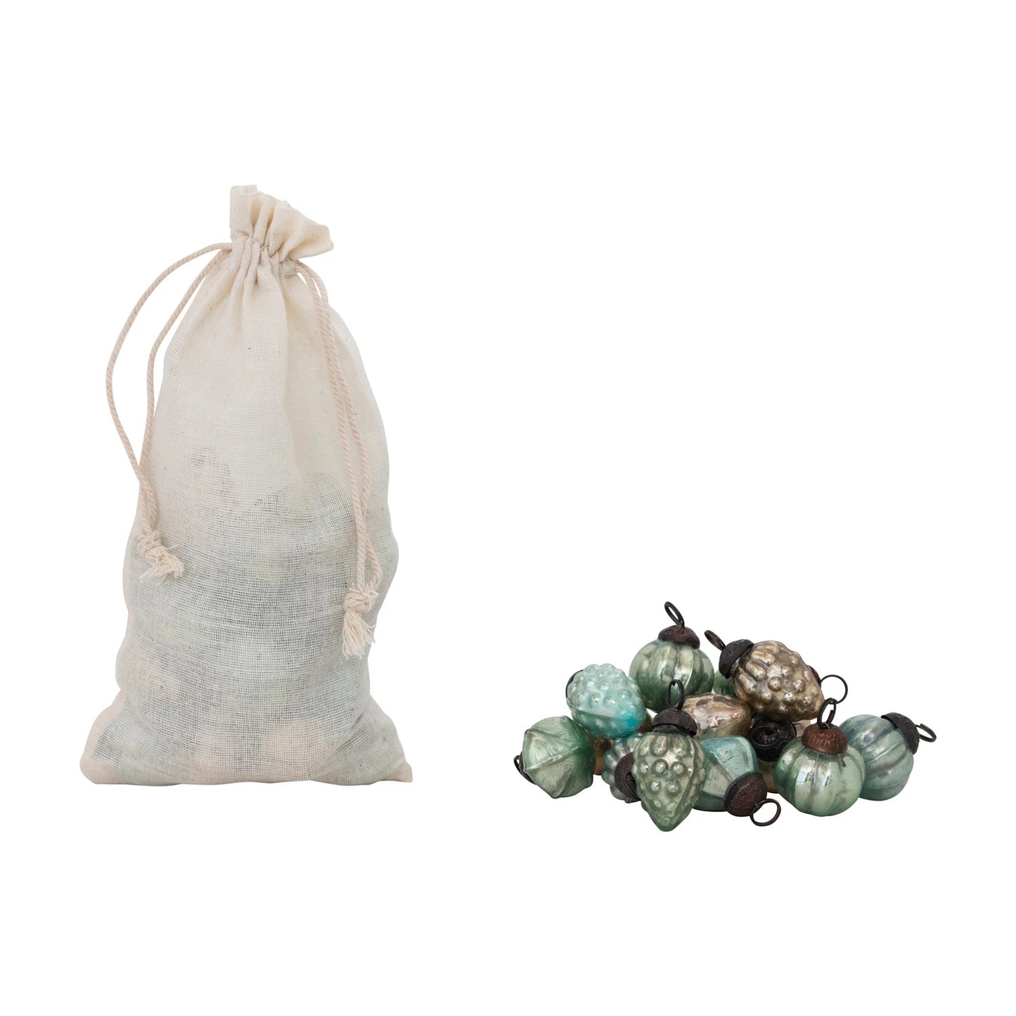 bag of ornaments with a pile of green and blue mercury glass ornaments next to it.