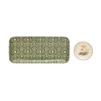 green mushroom patterned rectangle platter next to round plate with mushrooms displayed on a white background