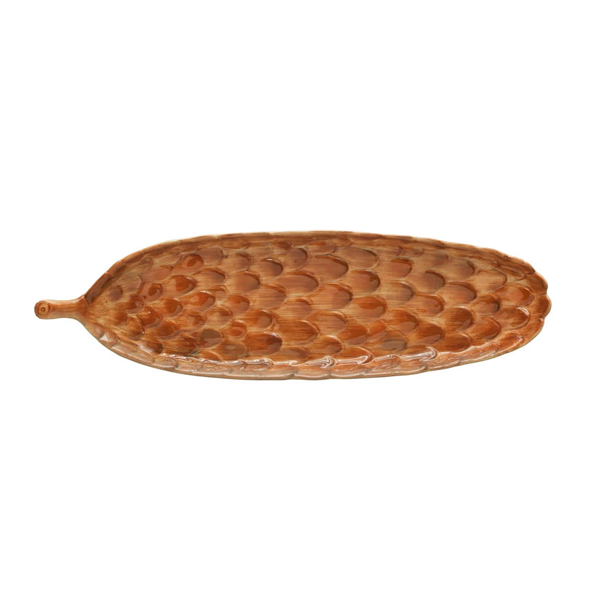 top view of the pinecone shape stoneware cracker dish displayed on a white background