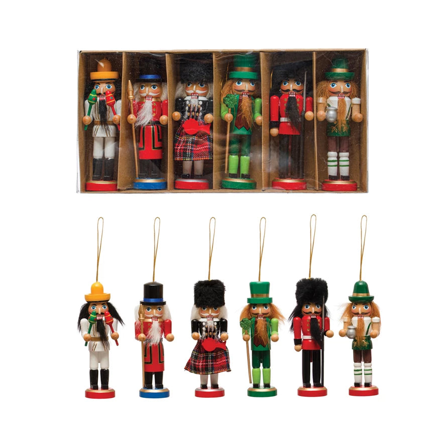 boxed set of nutcracker ornaments with another set of ornaments displayed below it.