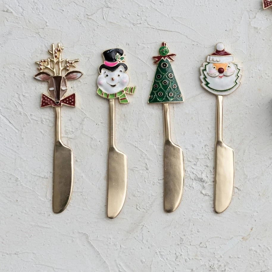 4 styles of christmas spreaders arranged on a plaster surface.