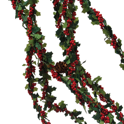 close up view of the holly leaf spray with red berries and natural pinecones displayed against a white background