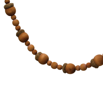 close up view of the paulownia wood acorn and bead garland displayed against a white background
