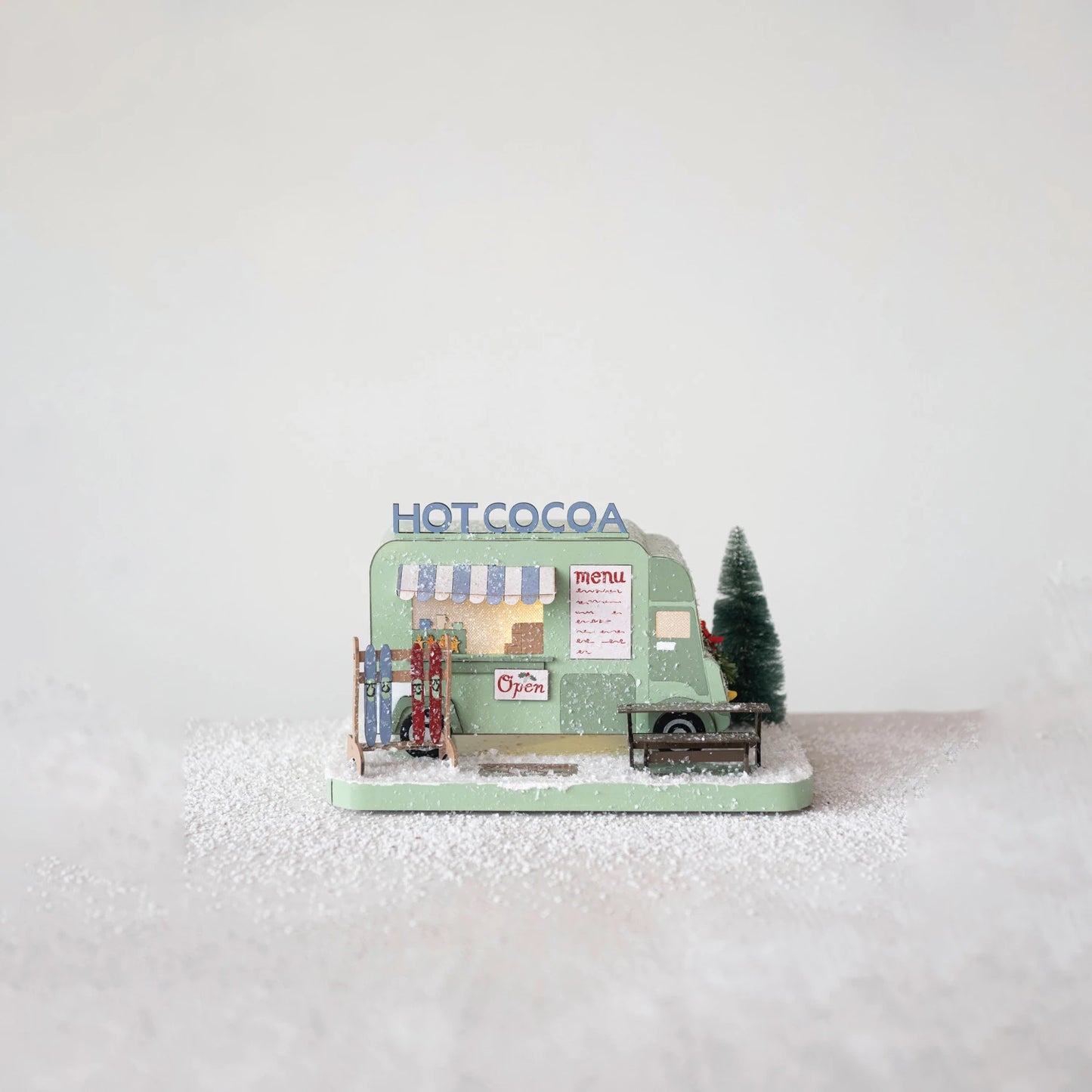 cocoa truck scene set on a table with artificial snow sprinkled around it.