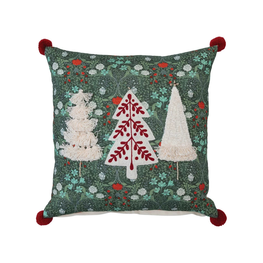 trees embroidered cotton slub pillow with red pom poms displayed against a white background