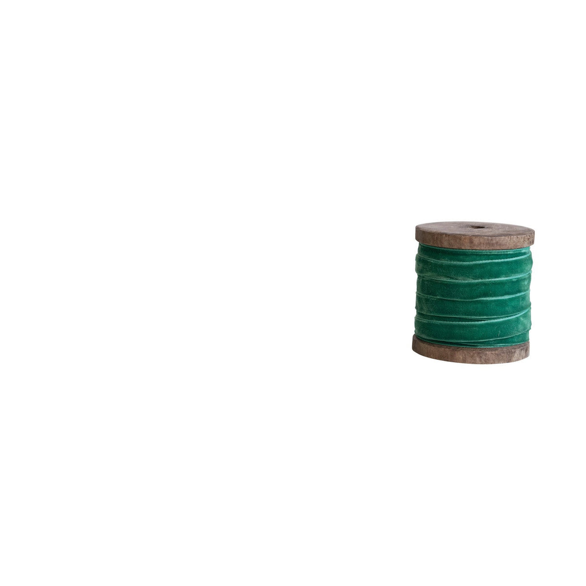 wooden spool of emerald green velvet ribbon