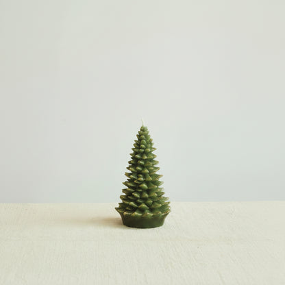 large evergreen tree candles next on a decorated surface