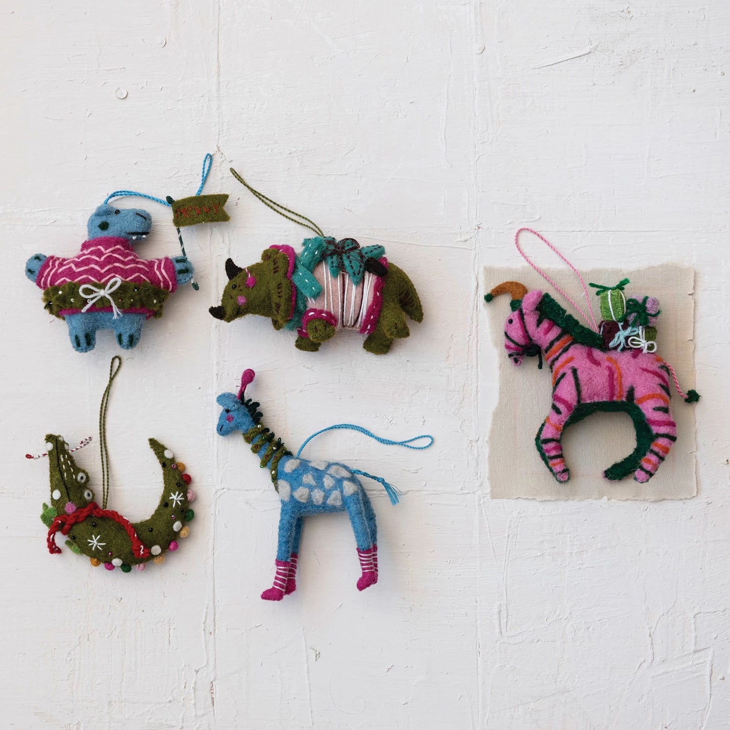 assorted animal ornaments arranged on a plaster background.