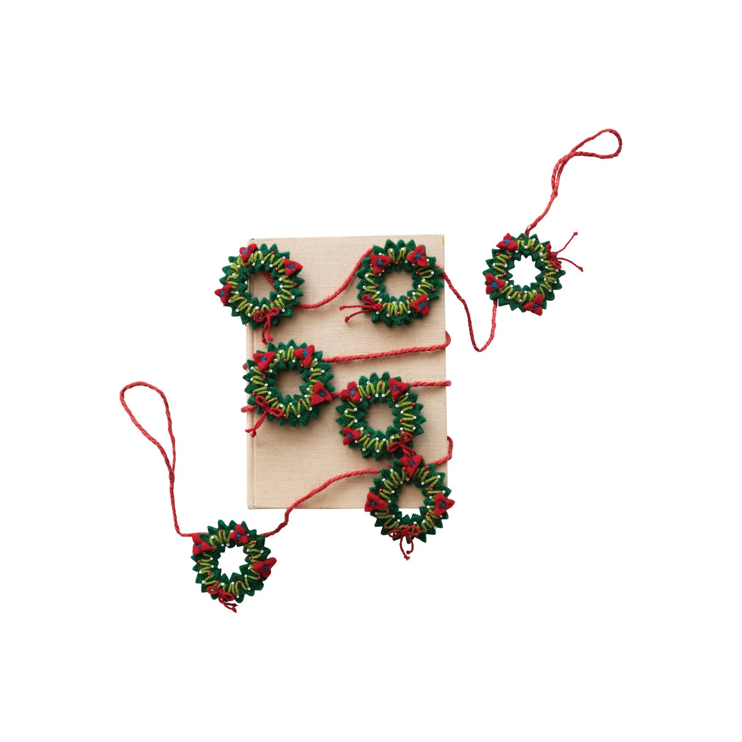 wreath garland wrapped around a piece of cardboard on a white background.