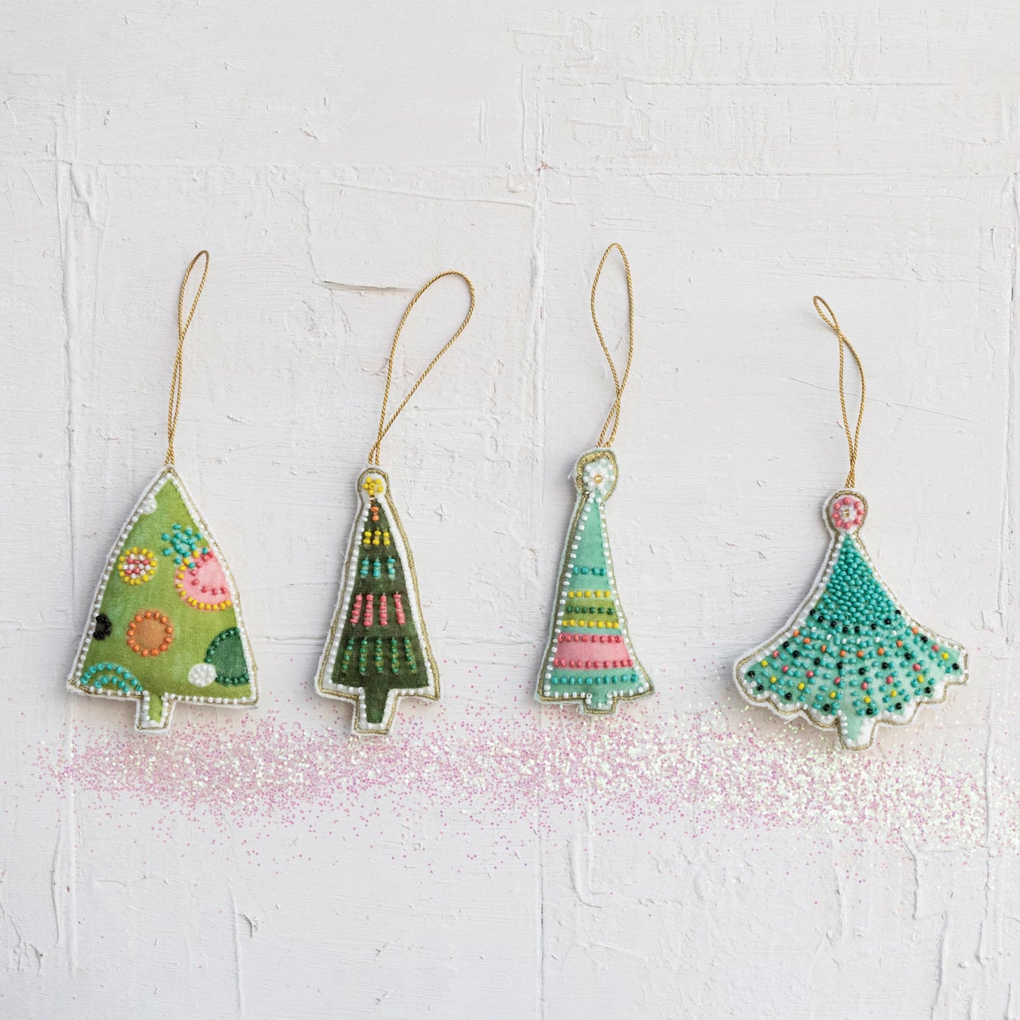 4 styles of blue and green velvet tree ornaments embroidered with colorful glass beads.