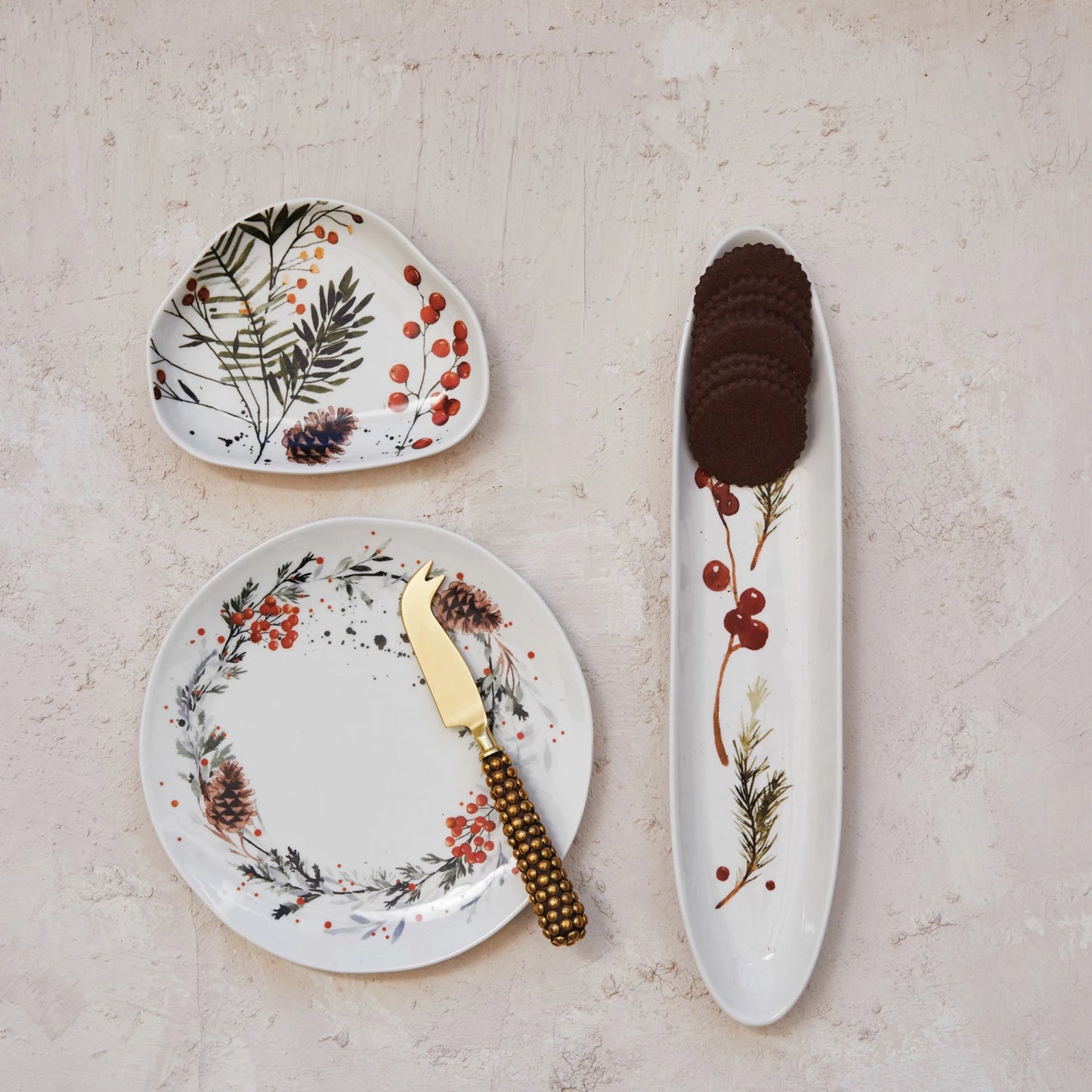 top view of a table with 3 assorted botanical dishes on it, the tray has crackers on it.