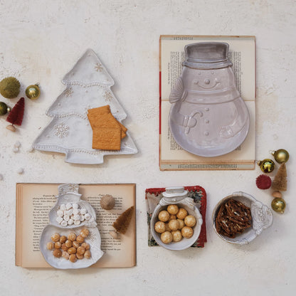 top view of table arranged with assorted holiday dishes filled with snacks.