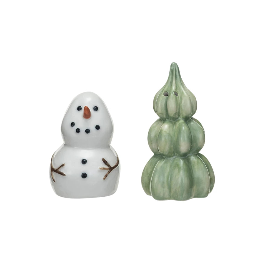 snowman and tree salt and pepper set shown on a white backgorund.