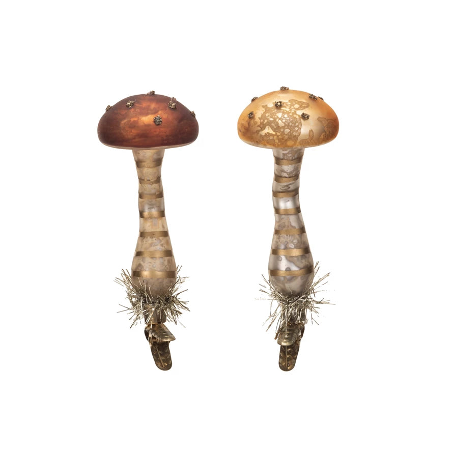 2 assorted glass mushrooms on a white background.