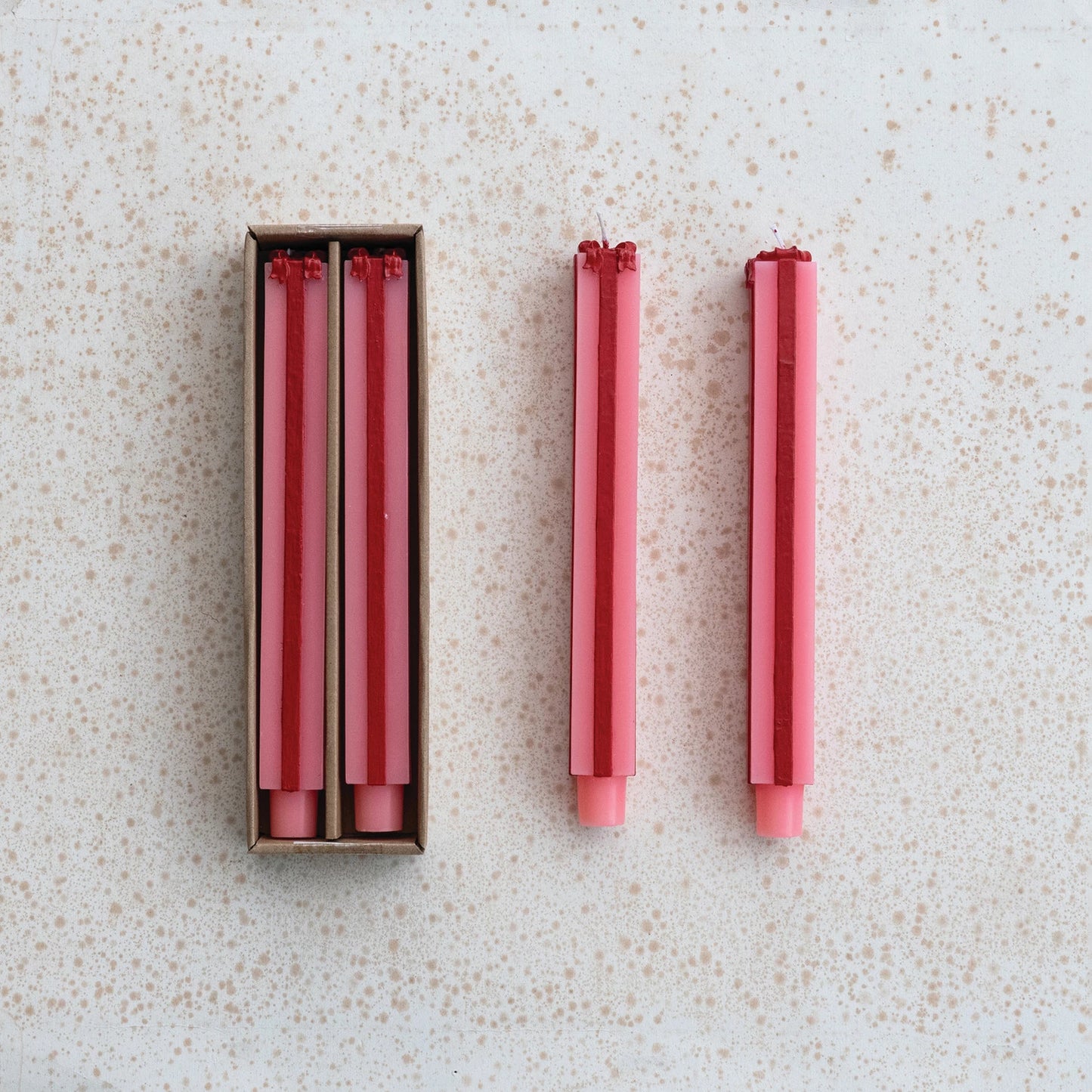 pink and red Package Shaped Taper Candles shown both in and out of their box packaging