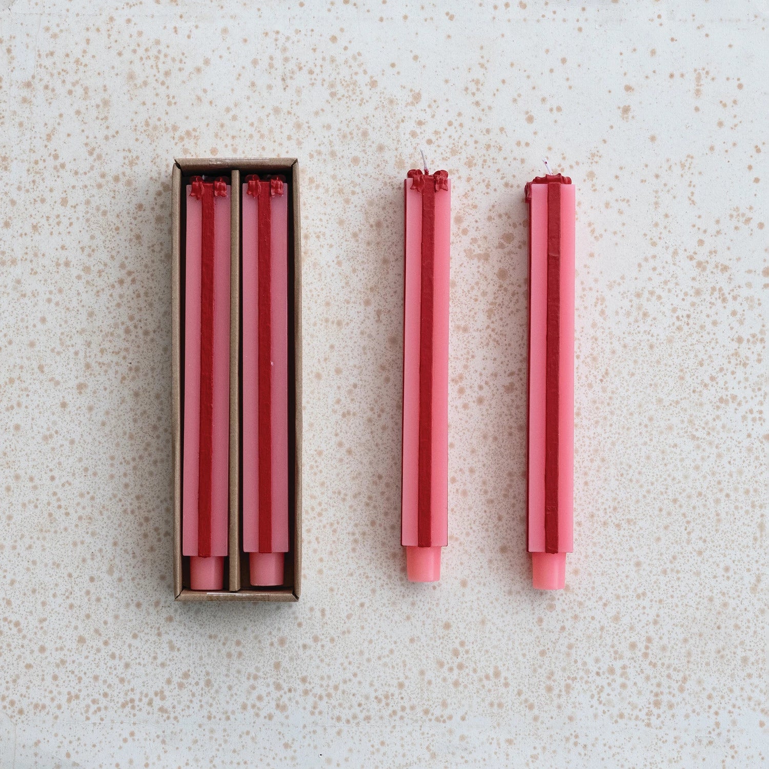 pink and red Package Shaped Taper Candles shown both in and out of their box packaging