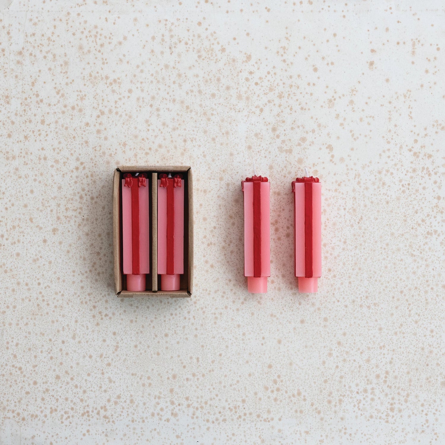 pink and red Short Package Shaped Taper Candles shown both in and out of the box packaging