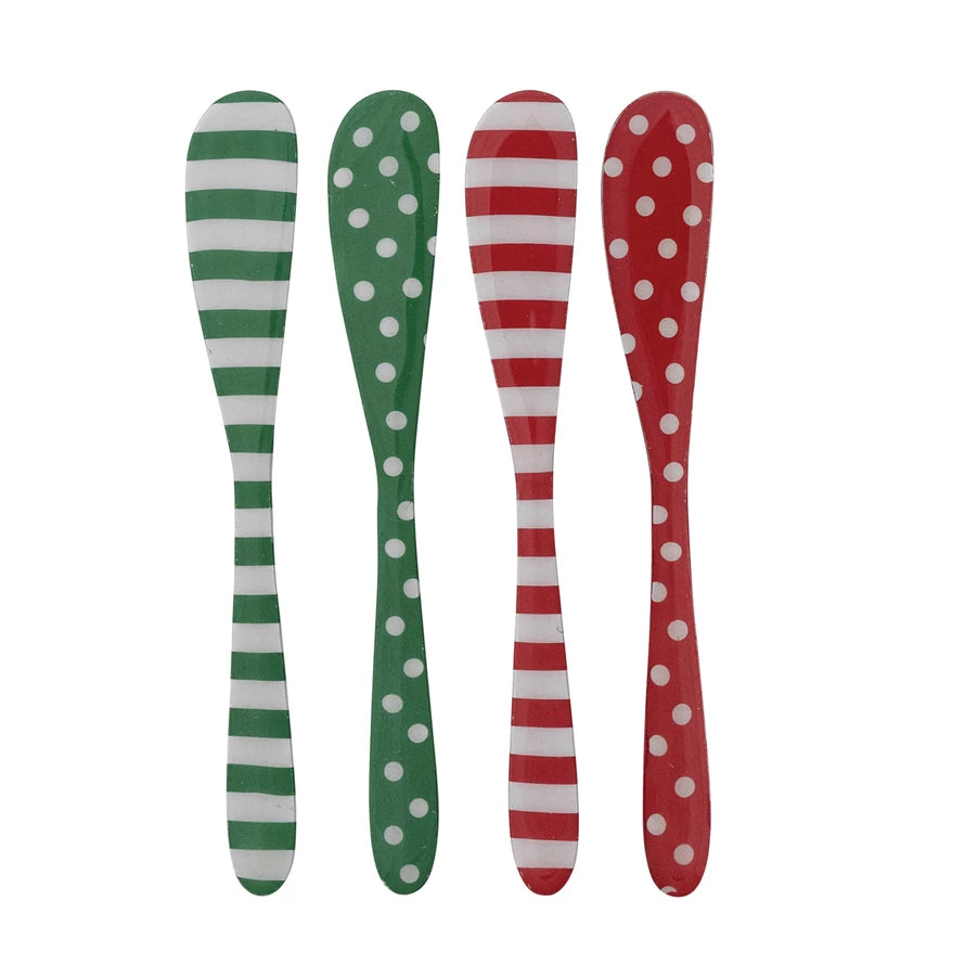 4 assorted Enameled  spreaders with red and green dots or stripes in a row on a white background