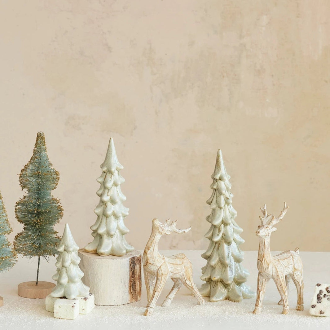 Stoneware Trees with Light Green Reactive Glaze arranged on a table with wooden deer and artificial snow