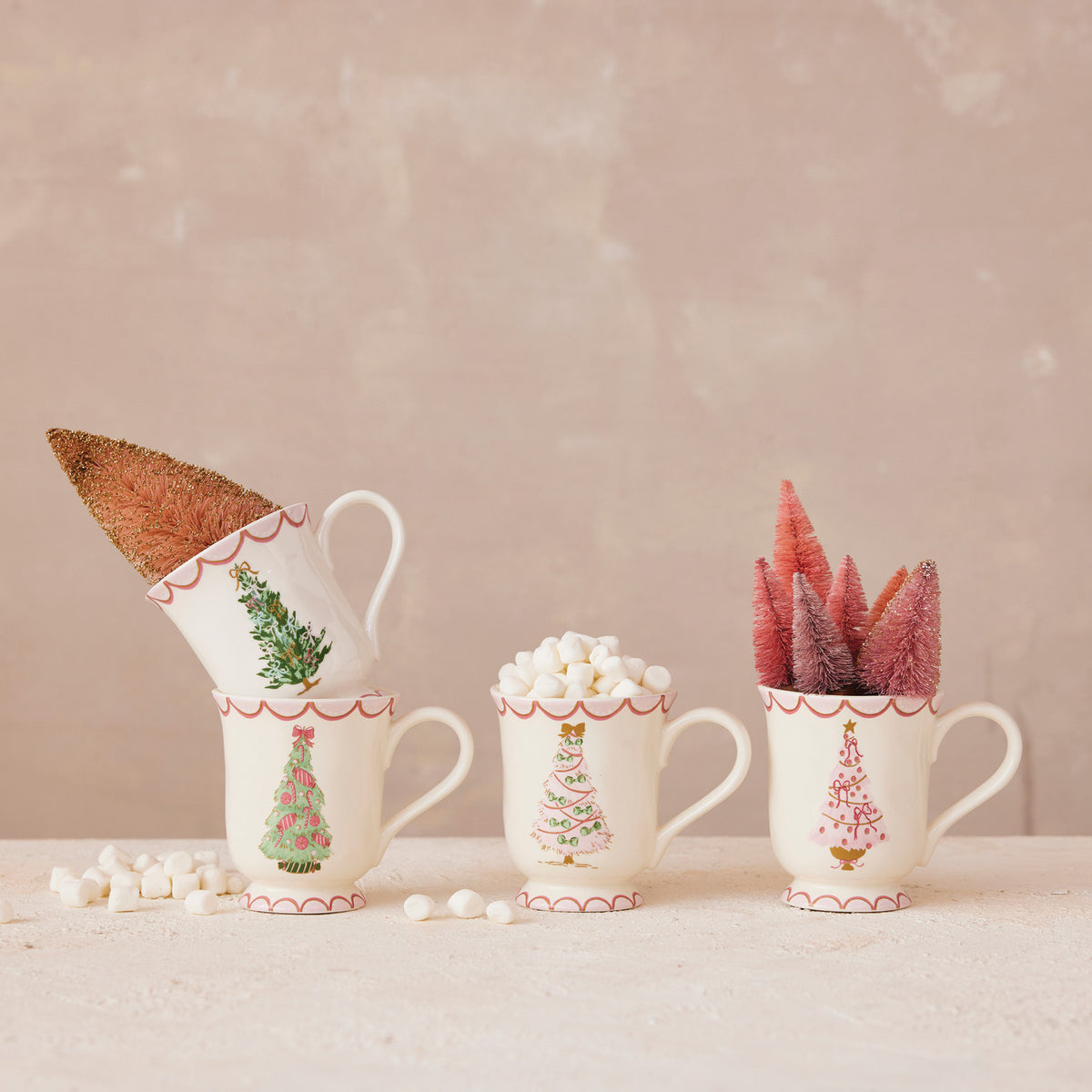 4 christmas tree mugs decorated with bottle brush trees and marshmallows 