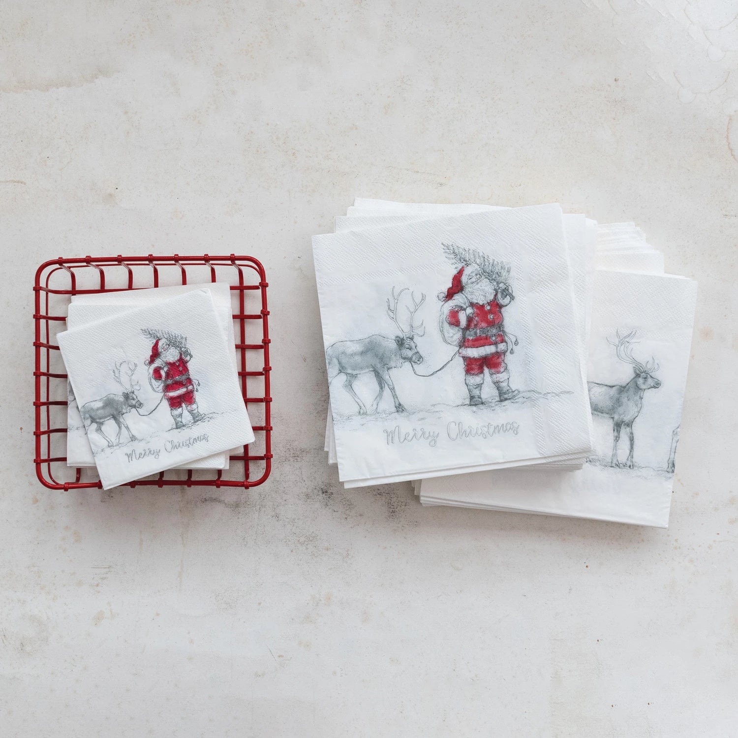 stacks of Santa & Reindeer Paper Napkins arranged on a marble surface