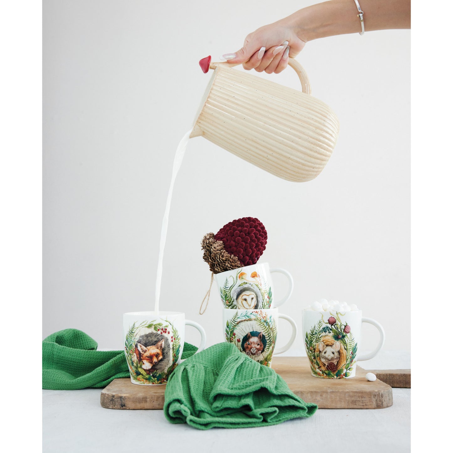4 animal mugs on a decorated surface