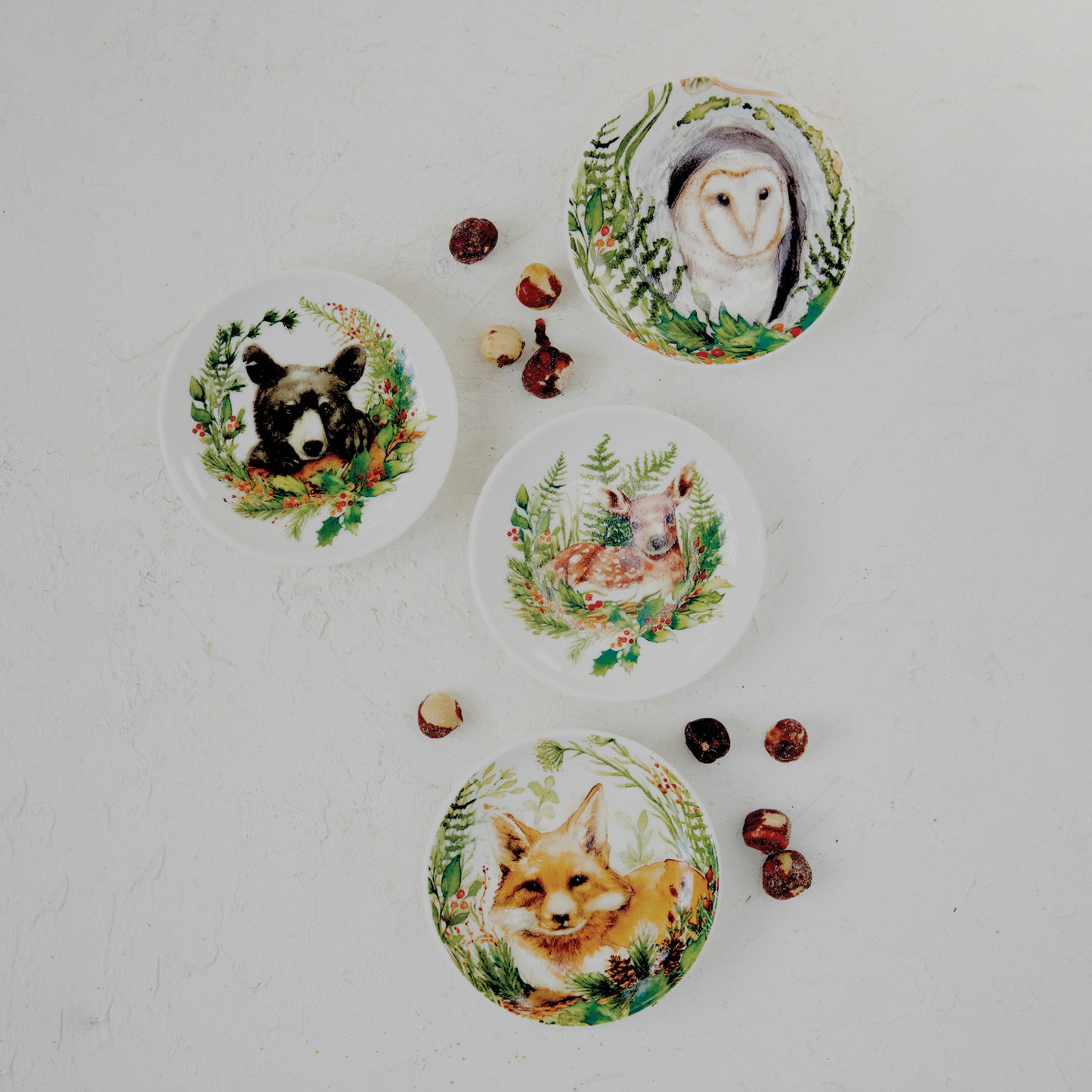 four animal small plates scattered around on a decorated surface 