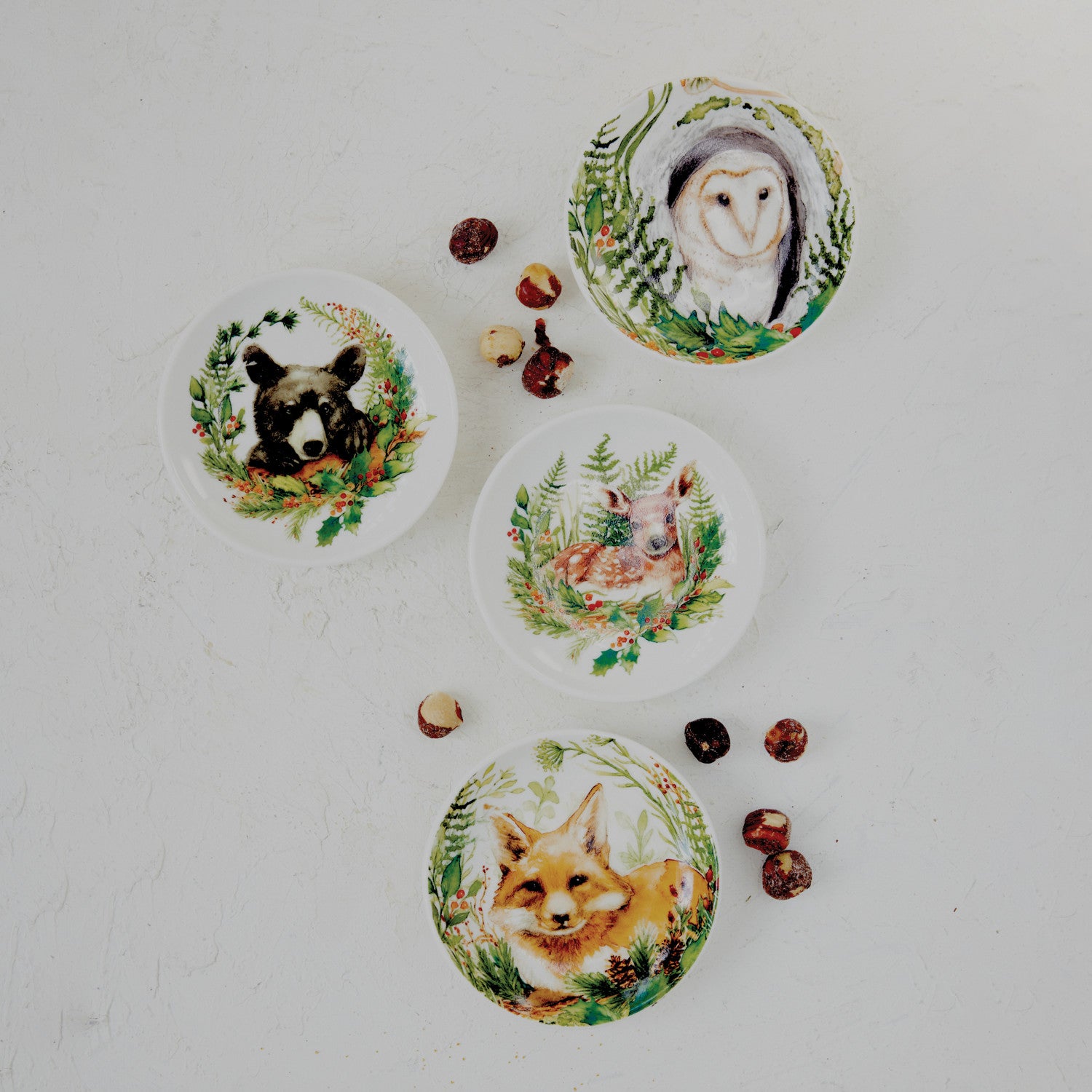 four animal small plates scattered around on a decorated surface 