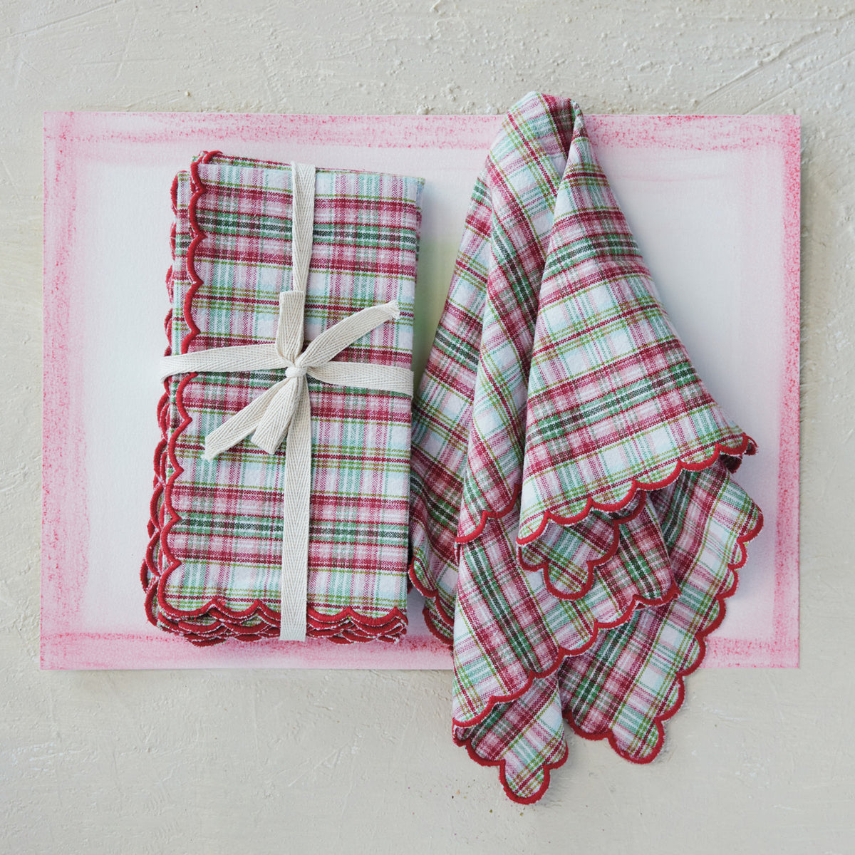 set of napkins next to a slightly folded napkin on a decorated surface