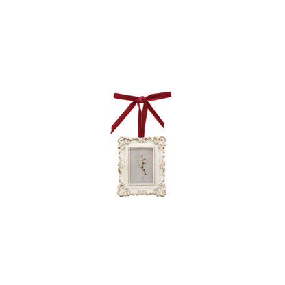 white ornament frame with red flower in frame