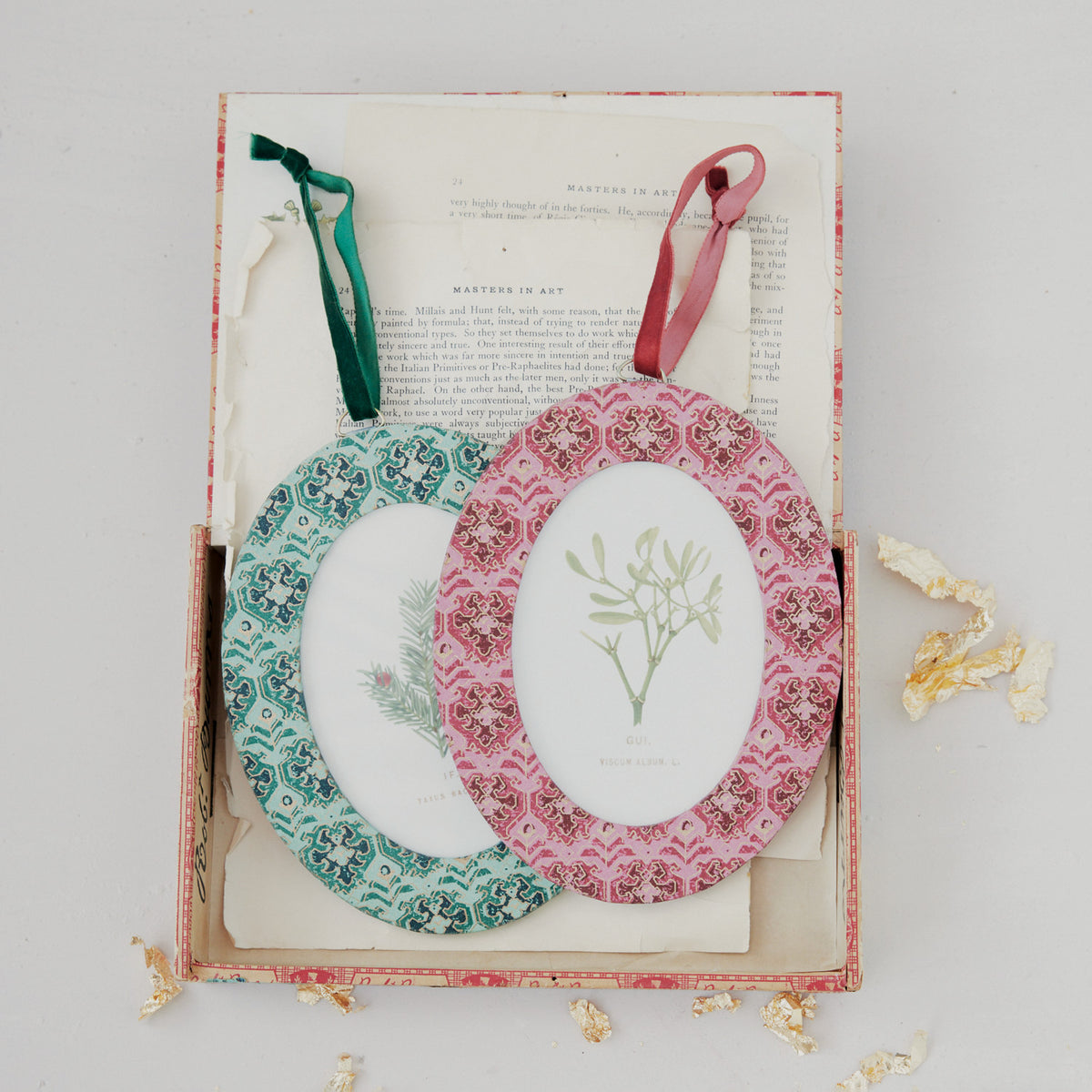 2 frame ornaments arranged on book pages