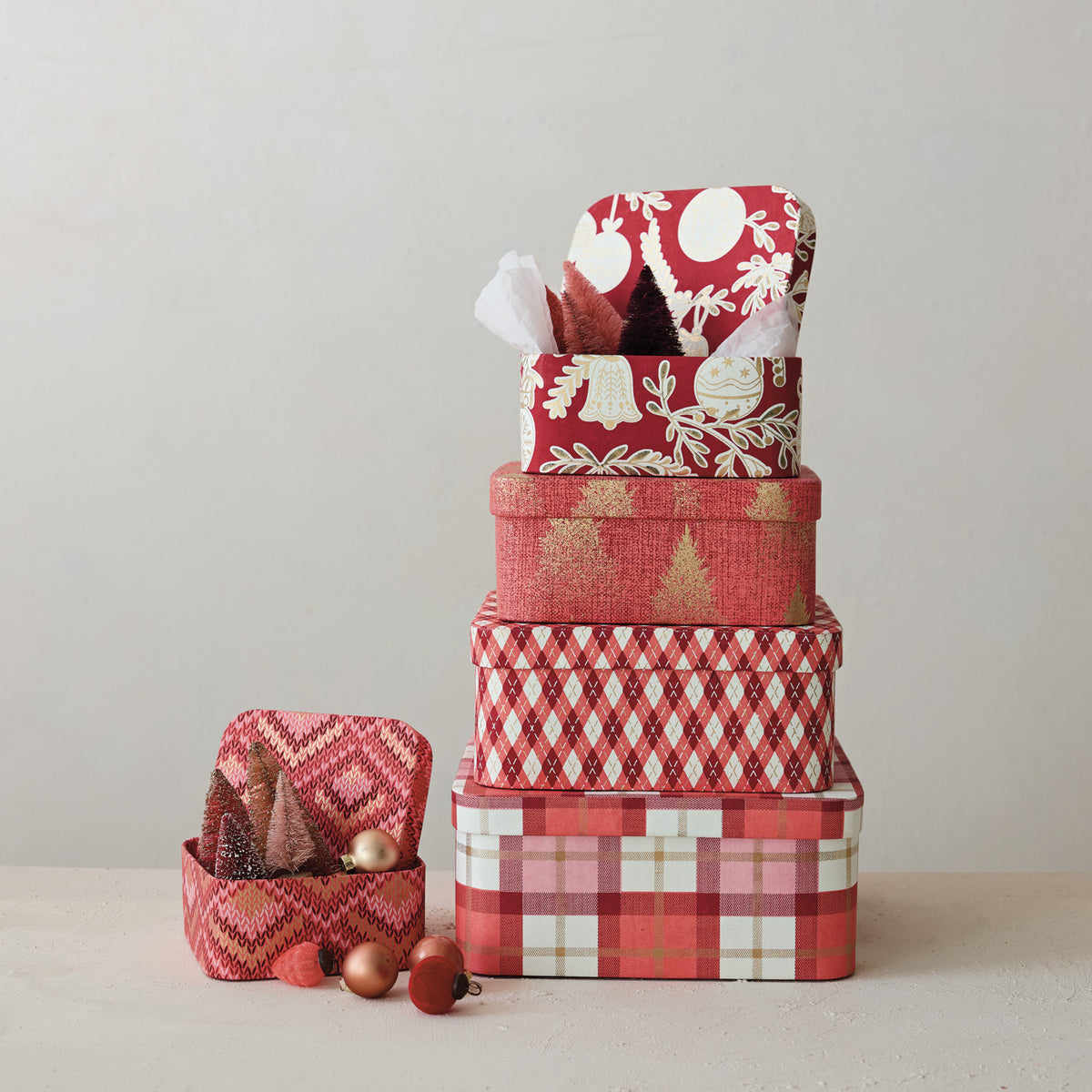 5 gift boxes stacked in a decorated setting