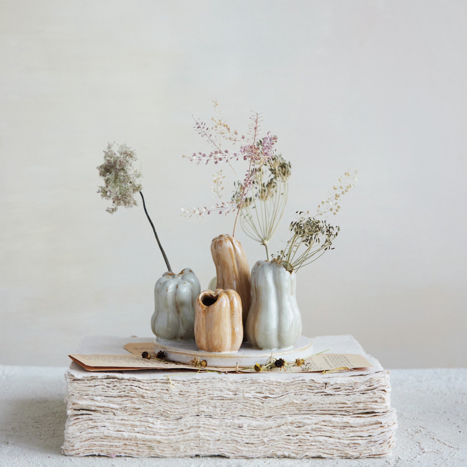 gourd & pumpkin vase on a decorated table with stems in the vase