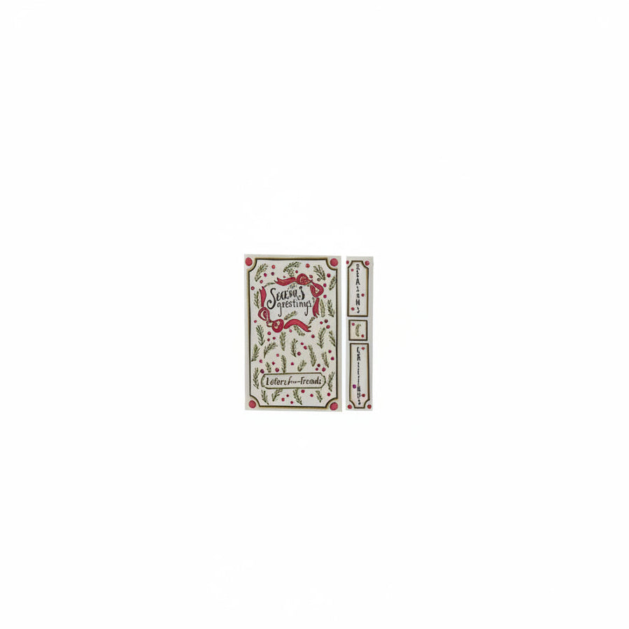 cover and spine views of cream colored book box titled 'season's greetings' with evergreen and red bow design
