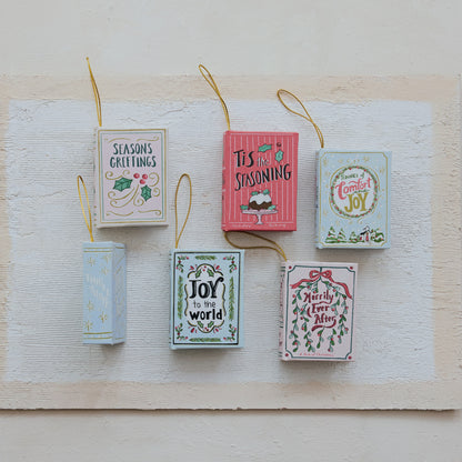 6 book ornaments on a decorated background