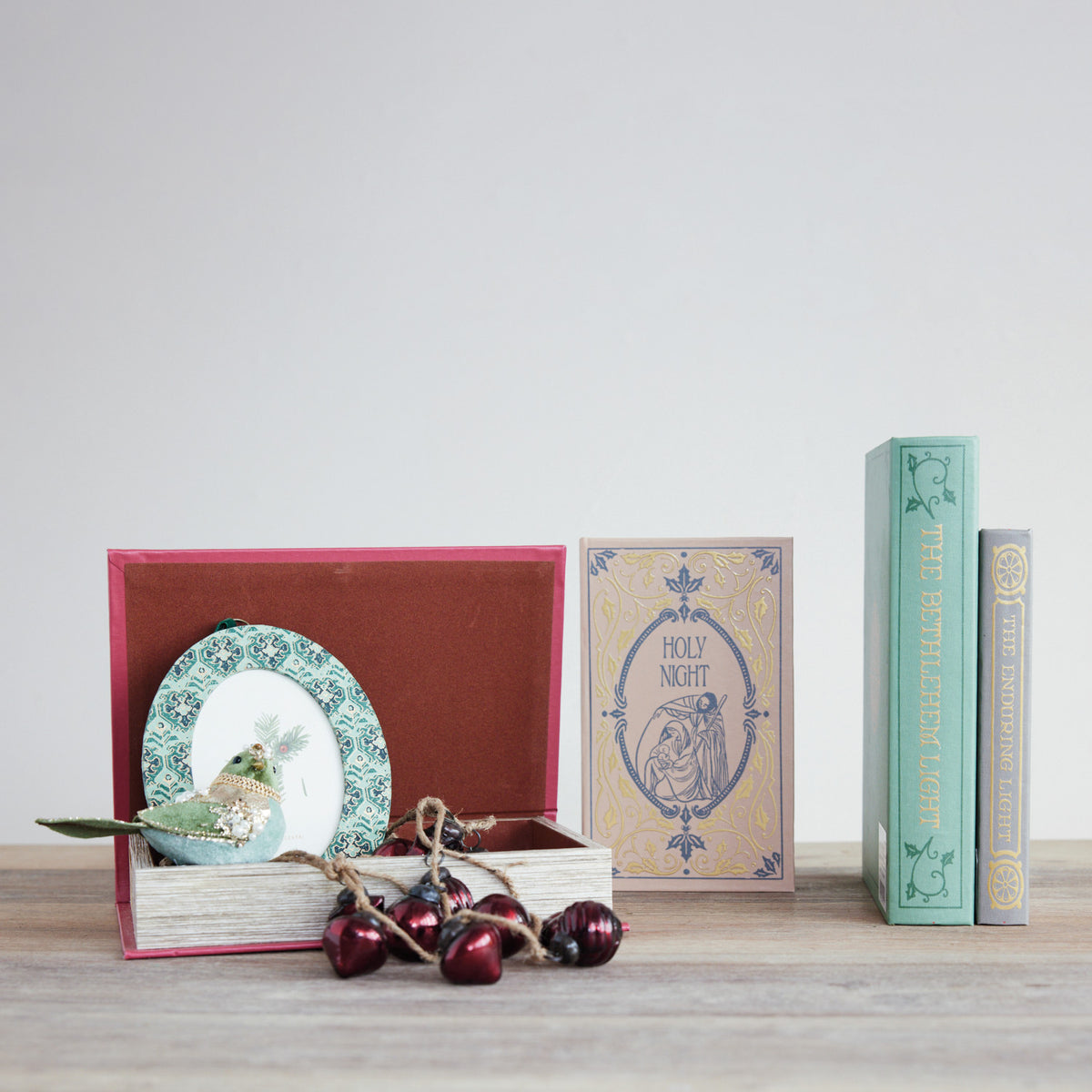 4 christmas themed book boxes in a decorated setting