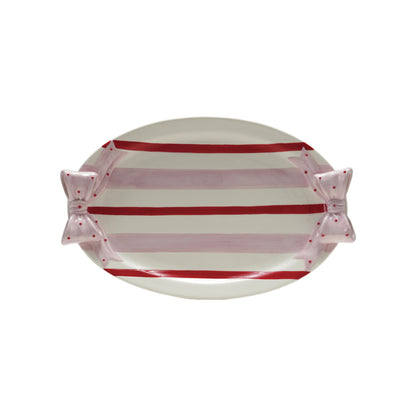 stripe and oval platter with bow handles shown on a white background