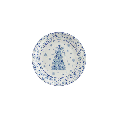 white plate with a blue christmas tree, blue snowflakes, and blue botanicals with stars