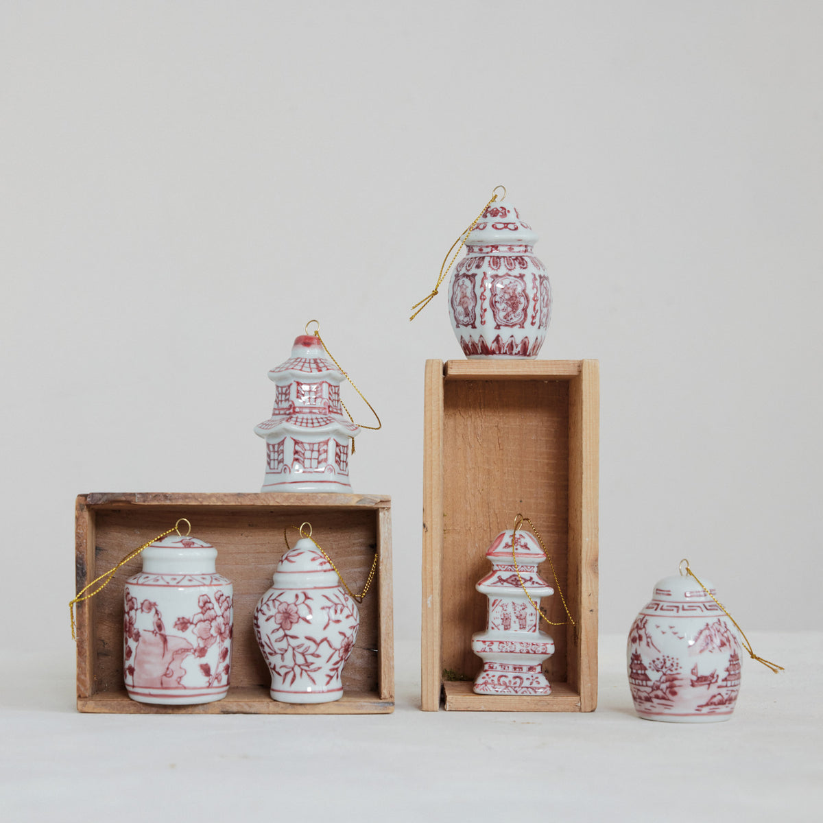 6 different red and white ginger jar ornaments on a decorated background