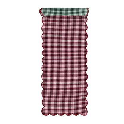red side of the gingham table runner rolled slightly to show the green side