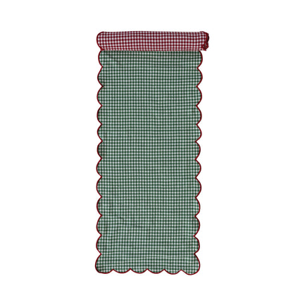 green side of the gingham table runner rolled slightly to show the red side