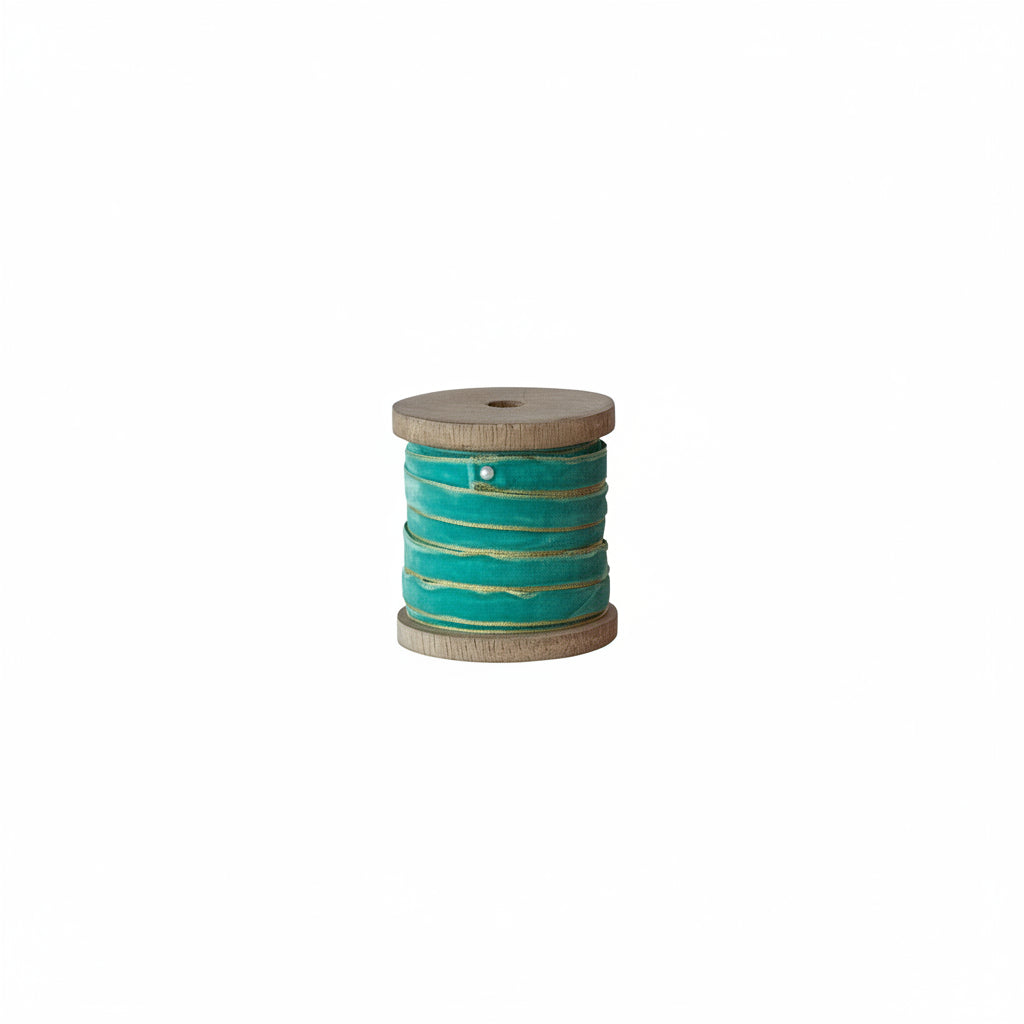 aqua ribbon on a wood spool